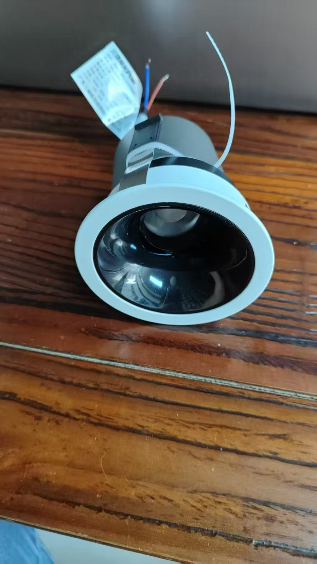 Original photograph of a recessed PAK luminaire with a white trim and deep black reflector